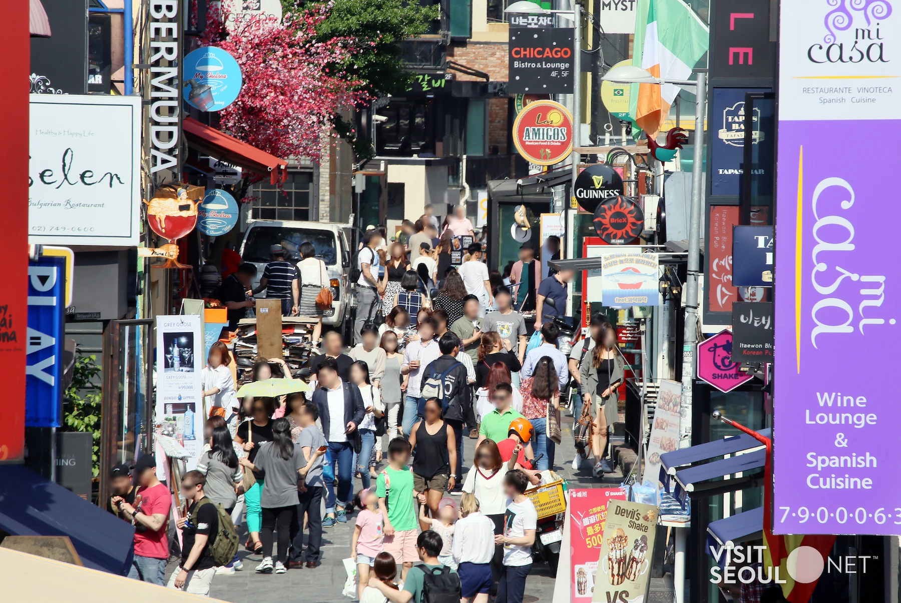 Itaewon World Food Street with international restaurants and pedestrians in Seoul.